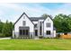 Beautifully landscaped two-story home with a well-manicured lawn and gray and white exterior at 5812 Shawood Dr, Raleigh, NC 27609