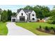 Landscaped two-story home features a long driveway leading to an attached garage at 5812 Shawood Dr, Raleigh, NC 27609