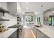 Gourmet kitchen featuring a large island, stone countertops, and stainless steel appliances with an adjacent dining area at 5812 Shawood Dr, Raleigh, NC 27609