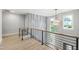 Stairway landing features hardwood floors, modern railing, and accent wall at 5812 Shawood Dr, Raleigh, NC 27609