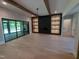 Open living space with wooden beams, hardwood floors, and access to outdoor patio at 5812 Shawood Dr, Raleigh, NC 27609