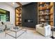 Bright living room with a fireplace and decorative shelving and a glass table over a white rug at 5812 Shawood Dr, Raleigh, NC 27609