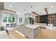 Open-concept living space featuring a modern kitchen, dining area, and cozy living room with a fireplace and built-in shelves at 5812 Shawood Dr, Raleigh, NC 27609