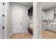 Bright mudroom features a built-in bench, storage cubbies, and access to the laundry room with white cabinets and hardwood flooring at 5812 Shawood Dr, Raleigh, NC 27609