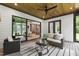 Relaxing outdoor living area featuring comfortable seating, a ceiling fan, and views of the open interior at 5812 Shawood Dr, Raleigh, NC 27609