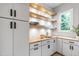 Organized pantry with wooden shelves, white cabinets, and ample storage space at 5812 Shawood Dr, Raleigh, NC 27609