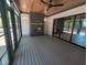 Inviting screened porch with fireplace, wooden ceilings, and sliding doors to the backyard at 5812 Shawood Dr, Raleigh, NC 27609