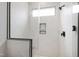 Beautiful shower featuring hexagonal tile and frameless glass doors at 5812 Shawood Dr, Raleigh, NC 27609