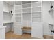 Spacious walk-in closet with custom shelving and a built-in bench at 5812 Shawood Dr, Raleigh, NC 27609