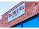 Building detail of brick building with a prominent Burial Beer Company sign at 600 Rocky Knob Ct, Raleigh, NC 27601