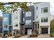 Modern townhome exterior featuring a clean design, private garage, and manicured landscaping at 600 Rocky Knob Ct, Raleigh, NC 27601