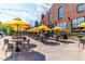 Expansive outdoor seating area with stylish tables and chairs under bright yellow umbrellas at 600 Rocky Knob Ct, Raleigh, NC 27601