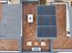 An aerial view of a rooftop patio with modern furniture, solar panels and wooden decking at 600 Rocky Knob Ct, Raleigh, NC 27601