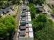 Aerial view of modern townhomes with rooftop patios in a green, tree-lined neighborhood at 602 Rocky Knob Ct, Raleigh, NC 27601