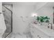 Modern bathroom with a double vanity, marble countertops, and glass-enclosed shower at 610 Rocky Knob Ct, Raleigh, NC 27601