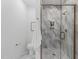 Modern bathroom featuring a glass-enclosed shower with marble tile and bronze hardware at 610 Rocky Knob Ct, Raleigh, NC 27601