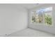 Bright bedroom with a large window offering a view of the outdoors and neighborhood at 610 Rocky Knob Ct, Raleigh, NC 27601