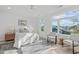 Bright bedroom with a large window, area rug, and comfortable seating at 610 Rocky Knob Ct, Raleigh, NC 27601