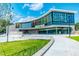 Modern building exterior featuring unique architecture, expansive glass windows, and manicured lawn at 610 Rocky Knob Ct, Raleigh, NC 27601
