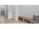A minimalist entryway featuring a bench, coat rack, and light wood floors at 610 Rocky Knob Ct, Raleigh, NC 27601