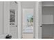 Hallway view through to a bright bedroom and bathroom with large mirror at 610 Rocky Knob Ct, Raleigh, NC 27601