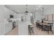 Bright, white kitchen with stainless steel appliances, marble countertops, and an island with seating at 610 Rocky Knob Ct, Raleigh, NC 27601