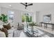 Light-filled living room with modern decor, large windows, and a cozy seating area at 610 Rocky Knob Ct, Raleigh, NC 27601