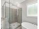 Modern bathroom featuring a glass enclosed shower with beautiful tile work and a soaking tub at 139 Goodison Park Rd, New Hill, NC 27562