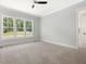 Bright and airy bedroom with plush carpet, large windows, and a neutral color scheme at 139 Goodison Park Rd, New Hill, NC 27562