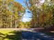 A circular driveway leads through a canopy of trees at 139 Goodison Park Rd, New Hill, NC 27562