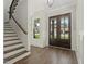 Inviting home entryway featuring hardwood floors, stairs, natural light, and paneled walls at 139 Goodison Park Rd, New Hill, NC 27562