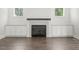 Elegant living room with fireplace, built-in cabinets, and hardwood floors providing a cozy ambiance at 139 Goodison Park Rd, New Hill, NC 27562