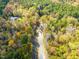Road through trees with home in view at 139 Goodison Park Rd, New Hill, NC 27562