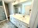 Bathroom featuring double vanity sinks, a large mirror, and tiled floors at 156 Southern Estates Dr, Sanford, NC 27330