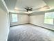 Spacious bedroom features a tray ceiling, fan, and two windows at 156 Southern Estates Dr, Sanford, NC 27330