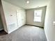 Comfortable carpeted bedroom featuring a window and a double door closet at 156 Southern Estates Dr, Sanford, NC 27330