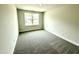 Cozy bedroom featuring a bright window overlooking the front yard at 156 Southern Estates Dr, Sanford, NC 27330