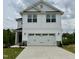 Charming two-story home featuring a two-car garage and stylish white siding at 156 Southern Estates Dr, Sanford, NC 27330