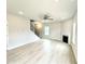 Open-concept living room with a fireplace and staircase with iron railing at 156 Southern Estates Dr, Sanford, NC 27330