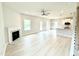 Bright living room with a fireplace, ceiling fan, and light wood floors at 156 Southern Estates Dr, Sanford, NC 27330