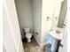 Small, stylish half bathroom featuring a pedestal sink at 156 Southern Estates Dr, Sanford, NC 27330