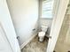 Toilet and view of shower in well-lit bathroom at 156 Southern Estates Dr, Sanford, NC 27330