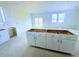 Kitchen with white cabinets and access to backyard at 38 Longdale Dr, Graham, NC 27253