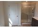 Bathroom with light-colored flooring, a tiled shower with glass doors, and a vanity at 39 Longdale Dr, Graham, NC 27253