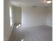 Carpeted bedroom featuring a window and a door leading to a closet or additional space at 39 Longdale Dr, Graham, NC 27253