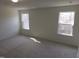 Spacious carpeted bedroom with dual windows providing plenty of natural light at 39 Longdale Dr, Graham, NC 27253