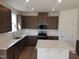 Modern kitchen with stainless appliances, white subway tile backsplash, and a large center island at 39 Longdale Dr, Graham, NC 27253