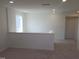 Upstairs landing with neutral carpeting, recessed lighting, and a view from the window at 39 Longdale Dr, Graham, NC 27253
