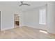 Bright bedroom with hardwood floors, ceiling fan, and view to bathroom at 779 Willard St, Durham, NC 27701