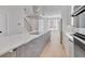 Modern kitchen with stainless steel appliances, large island with cooktop, and open floor plan connecting to the living area at 779 Willard St, Durham, NC 27701